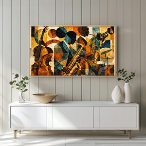 May include: Abstract art print featuring a jazz band. The artwork depicts musicians playing a cello, saxophone, and trumpet. The color palette includes shades of brown, blue, and gold. The print is framed in a wooden frame and is displayed on a white cabinet.