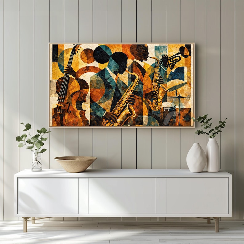May include: Abstract art print featuring a jazz band. The artwork depicts musicians playing a cello, saxophone, and trumpet. The color palette includes shades of brown, blue, and gold. The print is framed in a wooden frame and is displayed on a white cabinet.