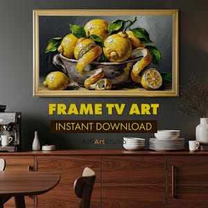 May include: A framed painting of lemons in a bowl with lemon peels. The painting is in a gold frame and is displayed above a wooden cabinet. The text "FRAME TV ART" and "INSTANT DOWNLOAD" are below the painting.