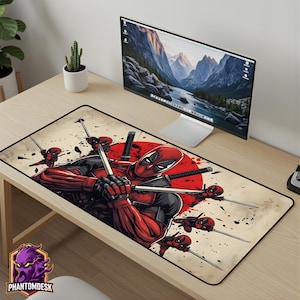 May include: A rectangular mousepad featuring a Deadpool graphic. The design includes Deadpool in a red and black suit, holding swords, with a red circle in the background. The Phantomdesk logo is in the lower left corner.