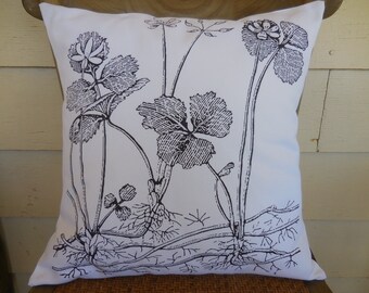 May include: Black and white pillow with a botanical print of leaves and flowers.