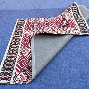 Traditional geometric rug with deep red ivory black and rust color combination