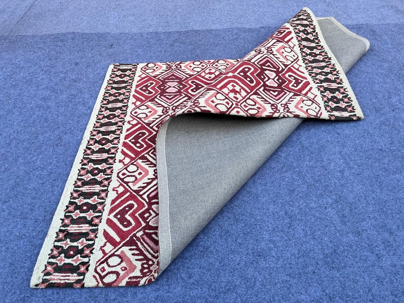 Traditional geometric rug with deep red ivory black and rust color combination