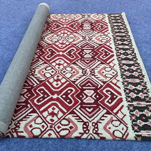 Traditional inspired area rug with burgundy cream and black geometric pattern