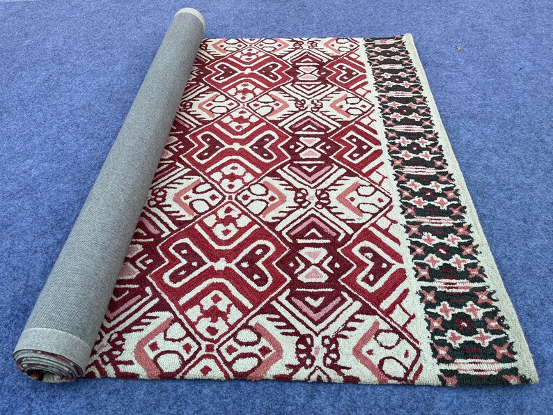 Traditional inspired area rug with burgundy cream and black geometric pattern