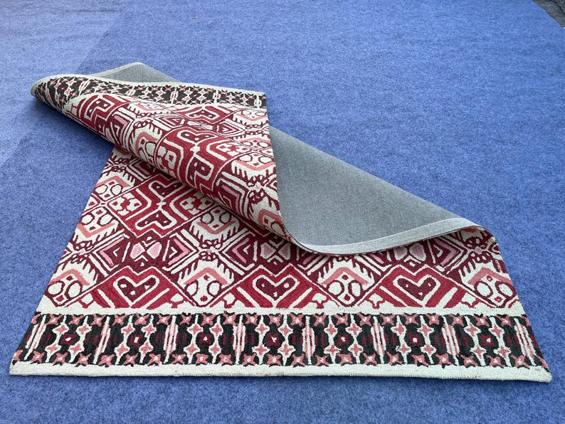 Geometric wool rug with deep red black and ivory color palette for modern interiors