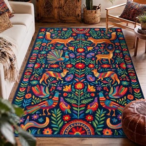 May include: A rectangular area rug featuring a dark blue background with a symmetrical, colorful pattern of foxes, deer, and birds interspersed with vibrant floral and leaf motifs. The design includes repeating orange, red, and teal elements.