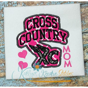 May include: Pink and black embroidered design with the words "Cross Country" and "Mom" with a pink heart on either side.