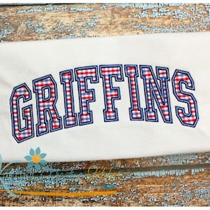 May include: White t-shirt with the name "GRIFFINS" embroidered in red, white, and blue gingham.