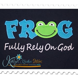May include: Embroidered design featuring a green frog with a smiling face and the word "FROG" in blue with a white outline. The text "Fully Rely On God" is written in white below the frog.