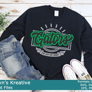 May include: A black sweatshirt with a green and white graphic that says "Gators" with the words "For Love and Honor" underneath.
