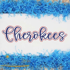 May include: Embroidered design of the word "Cherokees" in blue and red thread on a white background.