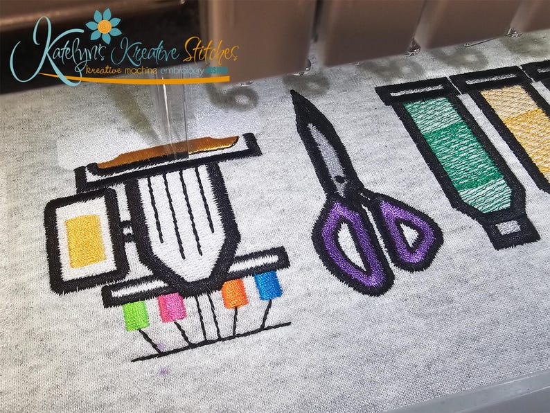 May include: Embroidered design featuring a sewing machine, scissors, and colorful thread spools. The sewing machine has a yellow square and a brown top. The scissors are purple and gray. The text "Katelyn's Kreative Stitches" is in the upper left corner.