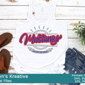 May include: White tank top with the word "Mustangs" in red and blue script, framed by a gray rectangle and sunburst design. Below the word "Mustangs" is the text "For Love and Honor". Brown sandals and blue jeans are also in the image.
