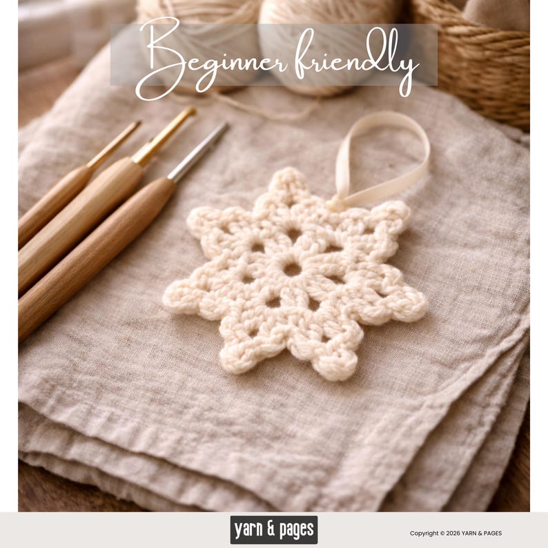 May include: A cream-colored, crocheted snowflake ornament with a ribbon loop, resting on a folded linen cloth. The image also shows three wooden crochet hooks and the text "Beginner friendly".