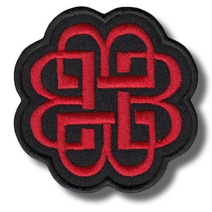 May include: Embroidered patch with a black background and a red, stylized, intertwined design. The patch has a scalloped edge. The red design is a repeating pattern of interlocking shapes.