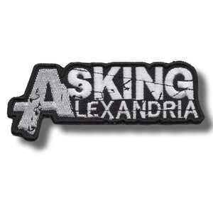 May include: Embroidered patch with the text "ASKING ALEXANDRIA" in white, outlined in black. The patch has a rectangular shape with a distressed font style, suitable for jackets, bags, or other fabric items.