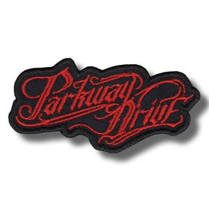 May include: Embroidered patch featuring the words "Parkway Drive" in red script on a black background. The patch has an irregular shape and a textured appearance, suggesting it is made of fabric.