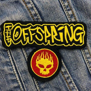 May include: Two embroidered patches. The top patch reads "THE OFFSPRING" in yellow on a black rectangular background. The bottom patch is circular, with a yellow skull design inside a red circle on a black background.