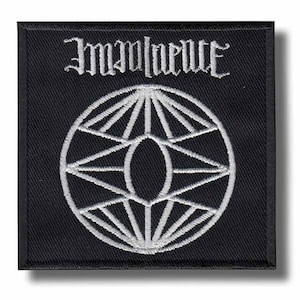 May include: Black square patch with white embroidered design. The patch features the word "Immanence" in gothic lettering above a geometric design of intersecting lines and circles. The patch is likely for clothing or accessories.