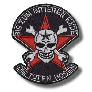 Puede incluir: Parche negro con una estrella roja, una calavera blanca y huesos cruzados. El parche tiene el texto blanco "BIS ZUM BITTEREN ENDE" y "DIE TOTEN HOSEN". Ideal para coser en chaquetas o bolsos.