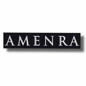 May include: Black rectangular patch with the embroidered word "AMEN RA" in white capital letters. The patch has a clean, minimalist design, suitable for various applications.