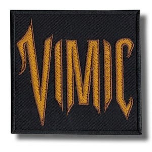 May include: Black square patch embroidered with the word "VIMIC" in gold thread. The letters are in a gothic style. The patch has a black border and is designed for application on clothing or accessories.