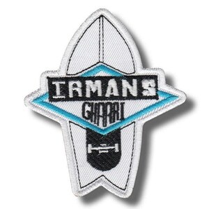 May include: Embroidered patch in the shape of a surfboard, featuring the text "IRMANS GHARBI" in black and white, with a turquoise diamond-shaped accent. A black skateboard graphic is at the bottom. The patch has a white border.