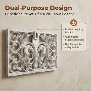 May include: White rectangular wall decor with a fleur-de-lis design and an antique finish. The decor has a built-in hanging bracket and includes a wall mount bracket. The text on the image says "Dual-Purpose Design" and "Functional trivet + fleur de lis wall decor."
