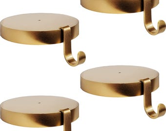 May include: Four gold-colored, circular candle holders with attached hooks. The holders have a flat, disc-shaped top and a curved hook extending from the side. The overall design is simple and elegant, suitable for various decor styles.