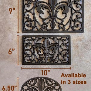 May include: Three decorative black metal door mats with a fleur-de-lis design. The largest is 13" x 9", the medium is 10" x 6", and the smallest is 9" x 6.50". The mats are available in 3 sizes.