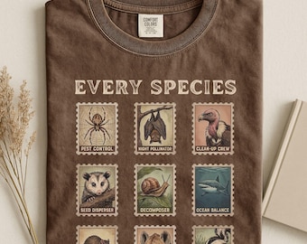 May include: An espresso brown t-shirt featuring the text EVERY SPECIES and a grid of nine postage stamp illustrations. Each stamp depicts an animal with a label: PEST CONTROL, NIGHT POLLINATOR, CLEAN-UP CREW, SEED DISPENSER, DECOMPOSER, and OCEAN BALANCE.