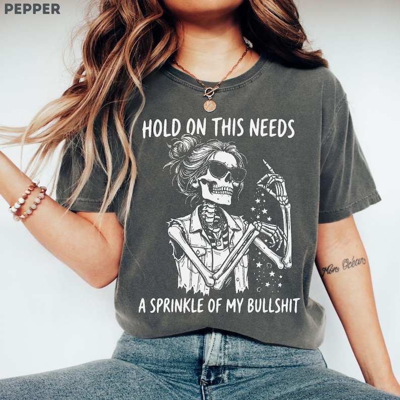 Perfect for women who love sarcastic humor, dark humor aesthetics, skeleton graphics, and chaotic unhinged energy. A funny retro graphic tee for introverts, tired women. Great for casual outfits, coffee runs, girls trips, concerts, festivals, lounging at home, or matching your “done with everything” mood. Makes a funny gift for best friends, coworkers, sisters, wives, girlfriends, and lovers of sarcastic statement shirts, edgy humor, retro skeleton art, and comfort colors graphic tees.