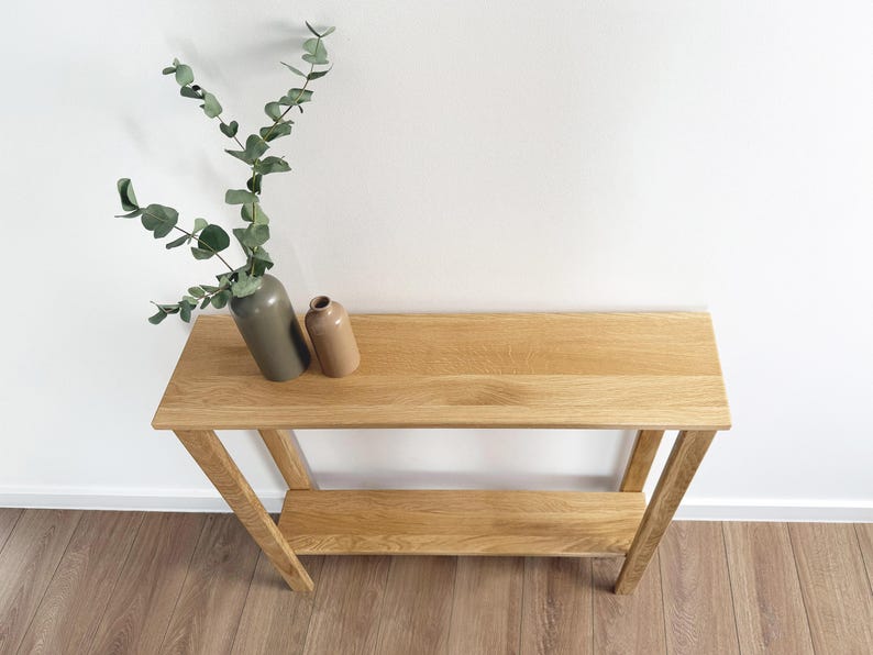 Solid oak hallway console table against white wall