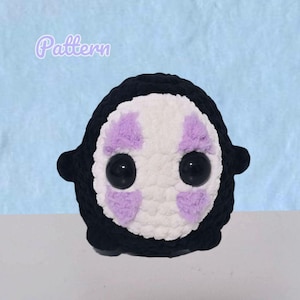May include: A handmade, plush, black and white character with large black eyes and lavender accents. The character has a round body and small arms. The word "Pattern" is written in a light purple script in the upper left corner. The background is a light blue.