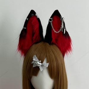 May include: A cosplay set featuring red and black fox ears with silver accents, a brown wig, and a pink fluffy tail. The set includes a silver star necklace and a silver bow hair clip. A pink fluffy tail with a black strap is also included.
