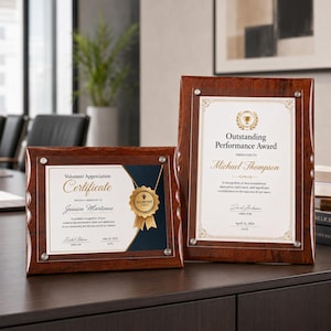 May include: Two rectangular wooden award plaques with clear acrylic covers held by silver metal standoffs. The left plaque displays a Volunteer Appreciation Certificate for Jessica Martinez, and the right plaque shows an Outstanding Performance Award for Michael Thompson.