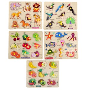 May include: A collection of wooden jigsaw puzzles with animal, bird, vegetable, sea animal, and fruit themes. Each puzzle has a wooden base with cut-out shapes and matching pieces. The puzzles are designed for educational play and feature colourful illustrations.