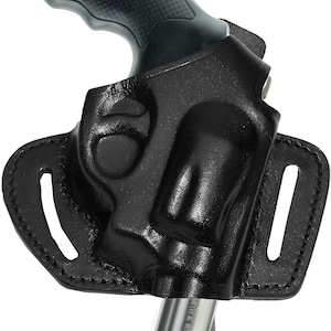 May include: Black leather holster with a revolver. The holster has a molded design to fit the gun's shape, with stitching around the edges. The revolver has a black grip and a silver barrel.