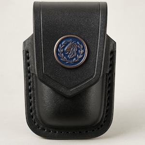 May include: Black leather case with a decorative emblem. The emblem features a blue circle with a horse head and laurel leaves. The case has a stitched border and a flap closure.
