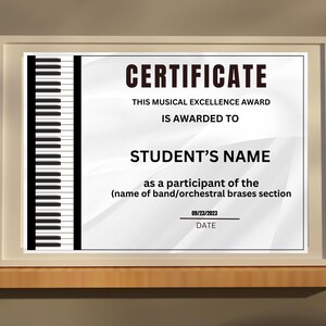 May include: Framed certificate with a piano keyboard design on the left. The certificate reads "CERTIFICATE" and "THIS MUSICAL EXCELLENCE AWARD IS AWARDED TO STUDENT'S NAME". Includes a date line for 23/09/2023.