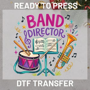 May include: A colorful DTF transfer design featuring the text BAND DIRECTOR in pink and purple letters. The graphic includes a purple drum with orange sticks, a music stand with an open book of sheet music, and a yellow trumpet with musical notes.