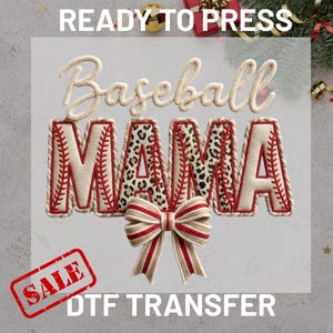 May include: A DTF transfer design featuring the words "Baseball MAMA". The letters are cream-coloured with red stitching and leopard print accents. A red and cream bow is at the bottom. The words "READY TO PRESS" and "SALE" are also visible.