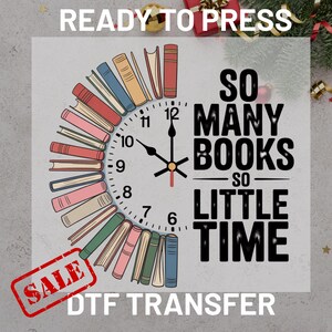May include: A DTF transfer design featuring a clock face made of books. The clock hands point to 10:09. The text reads "SO MANY BOOKS SO LITTLE TIME". A red "SALE" stamp is in the lower left corner. The words "READY TO PRESS" are at the top.