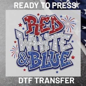 May include: A DTF transfer featuring the text RED WHITE & BLUE in a bold, layered font with a sparkling rhinestone-like texture. The design includes red, white, and blue colors, accented by small star shapes and firework bursts on a white background.