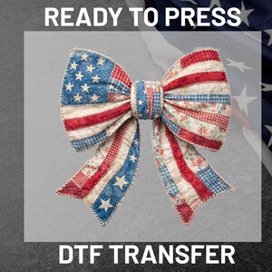 May include: A bow with a design inspired by the American flag, with red and white stripes and blue star-studded sections. The image includes the text "READY TO PRESS" and "DTF TRANSFER".