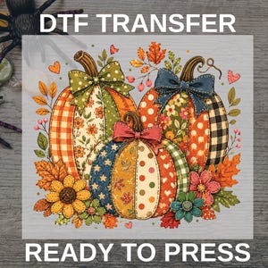 May include: A DTF TRANSFER READY TO PRESS graphic featuring three pumpkins decorated with various patterns including plaid, polka dots, and floral prints. The pumpkins are adorned with bows and surrounded by autumn leaves, flowers, and small hearts.