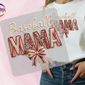 May include: A white t-shirt with the words "Baseball MAMA" in a baseball-themed design. The letters "M" and "A" have a leopard print pattern, while the other letters are designed to look like baseballs. A red and white bow is also included.