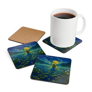 May include: A white ceramic mug filled with coffee sits on a square coaster with a blue and green illustration of a person in a lake. Two additional coasters with the same design are visible, along with a cork coaster.