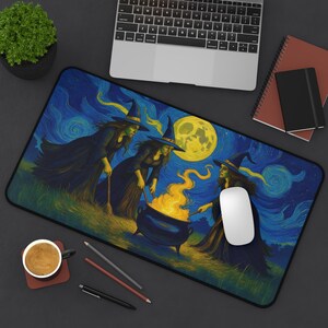 May include: A rectangular mouse mat featuring a painting of three witches gathered around a cauldron with a large yellow moon in the background. The witches are wearing black dresses and hats, with green skin. The background is a swirling blue and yellow night sky.